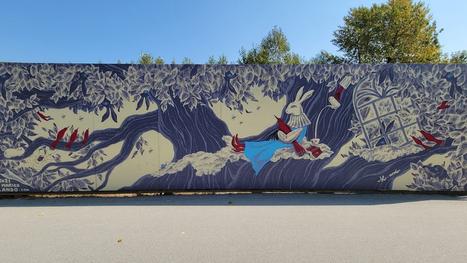 A mural of a rabbit and birds in a tree, by Mariko Ando